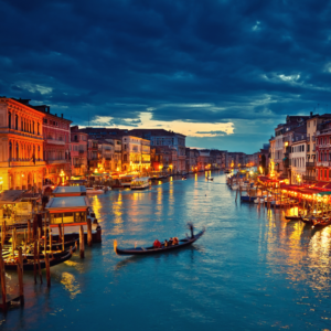Night reflections on a Venice canal with city lights